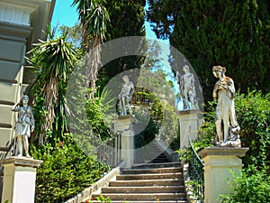 Concrete stairs and concrete statues and big luxurian green vegetation