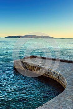 Concrete stairs and stone pier at town of Lovran in Kvarner gulf of Adriatic sea