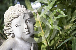 Concrete statue in the green garden