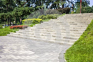 Concrete steps in a landscape recreation park with bushes