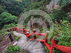 Concrete steps with red color handrail in a natural park of Ilan, Taiwan. photo