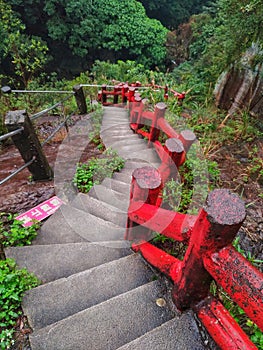 Concrete steps with red color handrail in a natural park of Ilan, Taiwan. The sign on the ground says & x22;Do not cross.& x22;. photo