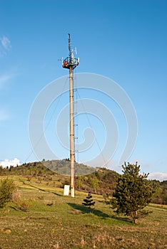 Concrete support with telecommunications antennae. Cellular tower in the wilderness.