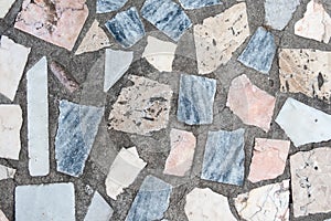 Concrete surface with multiple patches of large colored stones