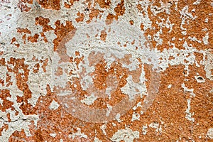 Concrete surface with the remains of whitewash and orange paint