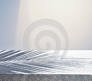 Concrete table counter with blur  shadow of coconut leaf on pastel background