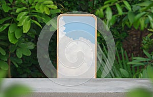 Concrete tabletop podium floor with mirror reflect cloud outdoors blur green leaf tropical forest nature landscape background.