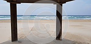 Concrete trail in the sand intended for disabled people goes to the sea