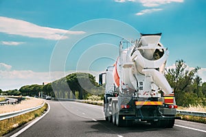 Concrete Transport Truck In-transit Mixer Unit In Motion On Coun