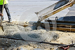 Concrete truck with pouring cement during to residential street sidewalk