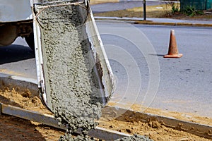 Concrete truck with pouring cement during to residential street