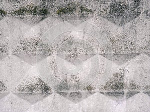 Concrete urban texture with a pattern of rhombuses and surface roughness. Grunge gray urban background photo