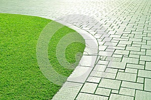 Concrete walkway and grass.