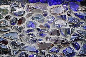 Concrete wall with broken glass elements