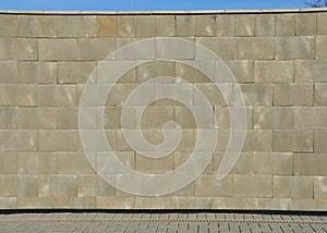 concrete wall made of smooth blocks. high dividing noise wall of the yard.