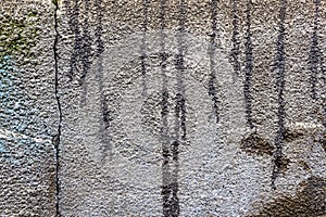 Concrete wall with oil spots and streaks of bitumen. Abstract background