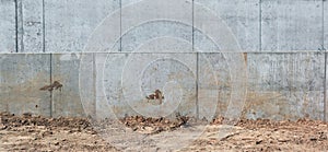 Concrete wall and sand in the construction of a new road