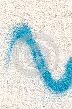 Concrete wall textured background including bright blue paint splatter