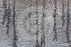 Concrete wall with traces of bitumen mastic. Abstract background