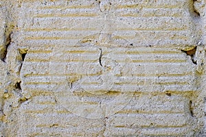 Concrete wall with vertical stripes from dismantled facing tiles