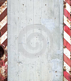 Concrete wall with warning stripes