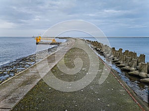 Concrete water pier in Swinoujscie with Baltic sea and breakwaters