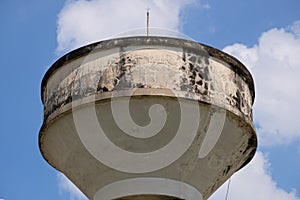 Concrete water tower soars into cloudy sky