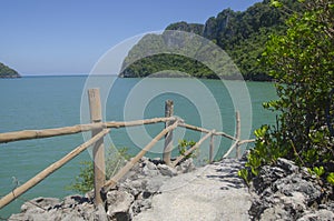 Concrete way with wooden fence to the sea