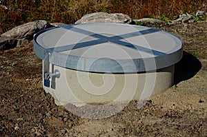 Concrete well well covered with a round concrete lid. a fall into a well often ends tragically with drowning, suffocation or fract