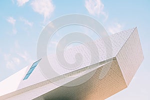 Concrete white modern building with interesting textures under the cloudy sky