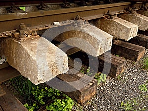 Concrete and wooden sleepers extracted with rail rods in railway station stock waiting for transport to steel foundry