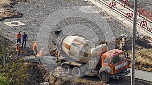 Concrete works for road construction with many workers and mixer timelapse