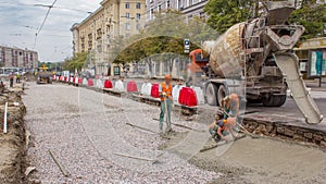 Concrete works for road maintenance construction with many workers and mixer machine timelapse