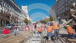 Concrete works for road maintenance construction with many workers and mixer machine timelapse