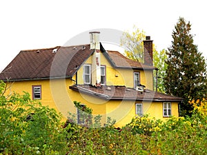 Condemned and abandoned yellow city house.