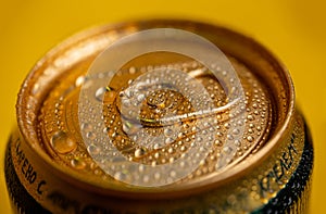 condensate on a cold metal beer can on a yellow background