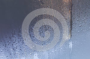 Condensate drops on the glass of a plastic window. Freezing and the formation of condensation and mold on the new