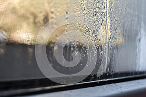 Condensate drops on the glass of a plastic window. Freezing and the formation of condensation and mold on the new