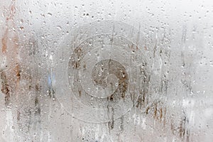 Condensation on the clear glass window, Water drops, Rain. Window glass with high air humidity. Background of natural water