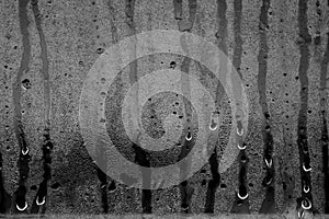 Condensation drops on glass in black and white.