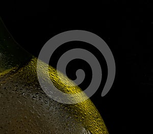 Condensation on gold beer bottle