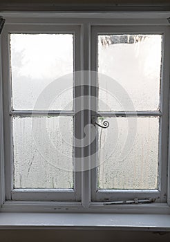 Condensation on old window in winter in England, UK