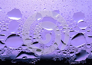 Condensation, Vapor, Rain, Water Drops Of Various Sizes On A Glass Surface. Purple Tone Color