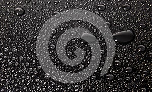 Condensation water drops on black glass background. Rain droplets with on dark surface. Abstract wet texture