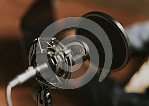 Condense microphone with a pop filter in a studio photo