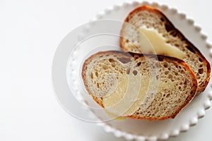 Condense milk and french bread on plate with vegetable juice