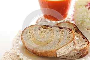 Condense milk and french bread on plate with vegetable juice