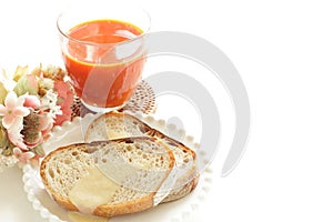 Condense milk and french bread on plate with vegetable juice