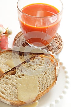 Condense milk and french bread on plate with vegetable juice