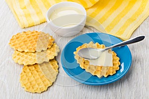 Condensed milk, napkin, wafer cookies with milk, spoon in saucer